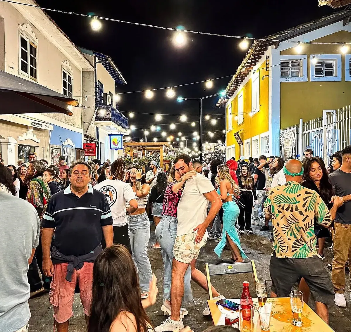 Pessoas dançando à noite na Rua do Meio iluminada