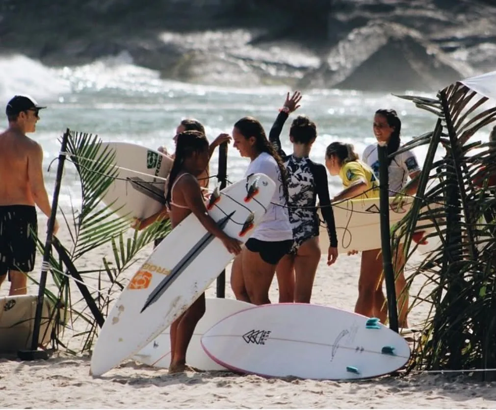 Atletas com pranchas na areia antes da bateria